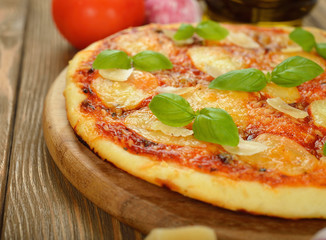 Pizza on brown background closeup