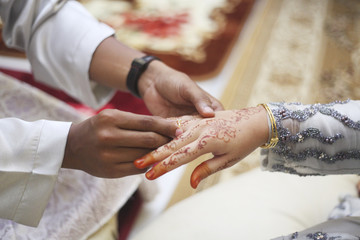 Obraz na płótnie Canvas picture of man putting wedding ring on woman hand