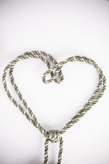 Rope valentine hart of simple design on white with copy space