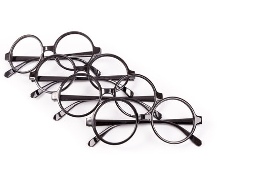 Stack of black glasses isolated on white