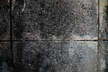 Old cement wall texture of dark color.