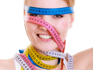Obsessed fit woman with measure tapes. Time for diet slimming.