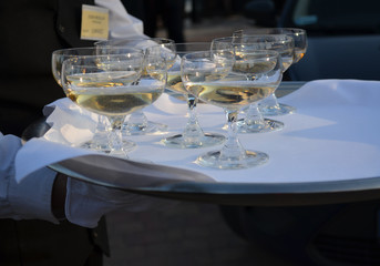 Champagne on a tray on an elegant outdoor party