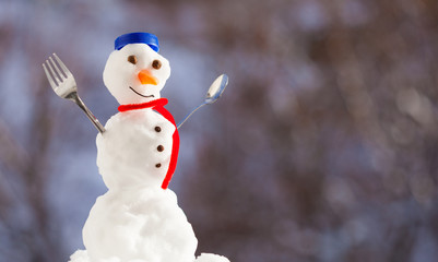 Little happy christmas snowman with fork outdoor. Winter season.