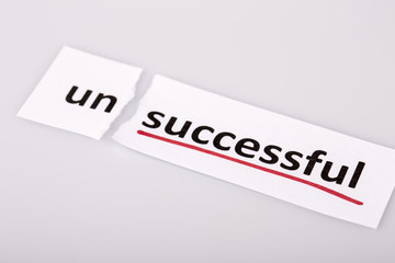 The word unsuccessful changed to successful on torn paper