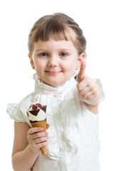 happy child girl eating ice cream and showing thumb up