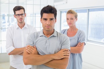 Obraz premium Casual business team looking at camera with arms crossed