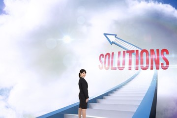 Obraz premium Solutions against red staircase arrow pointing up against sky