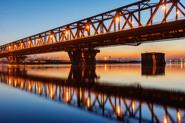 Steel bridge across river at night