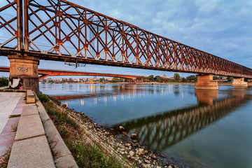 Steel bridge across river at night