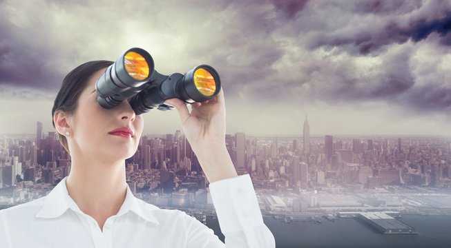 Composite image of business woman looking through binoculars