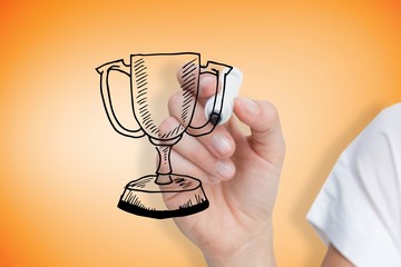 Composite image of businesswoman drawing winners cup