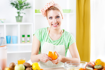 Young woman peeling oranges