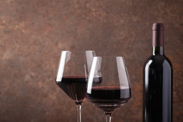 Glass with red wine and old barrel.