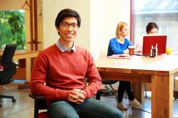 Smiling young asian student in classroom