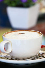 Cappuccino coffee in a white cup