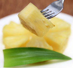 Macro of sliced pineapple with fork