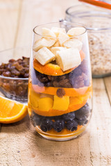Glass of mixed fresh fruits and raisins