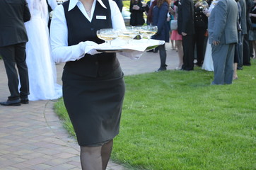 Waitress carries a tray of champagne for an elegant event