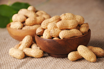 Shelled peanuts in wooden bowl