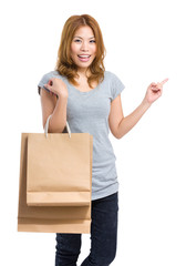 Girl with shopping bag of point a finger