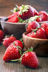 healthily raised organic strawberries in a wooden bowl