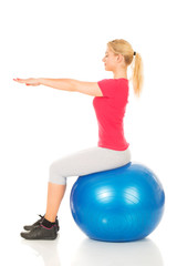 Fitness woman sitting on pilates ball