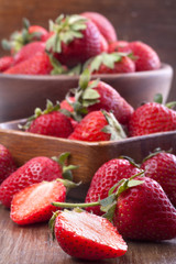 healthily raised organic strawberries in a wooden bowls