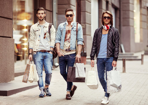 Three Young male fashion metraseksuals shop shopping walk