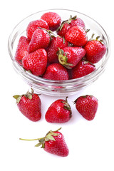 healthily raised organic strawberries in a glass bowl on white