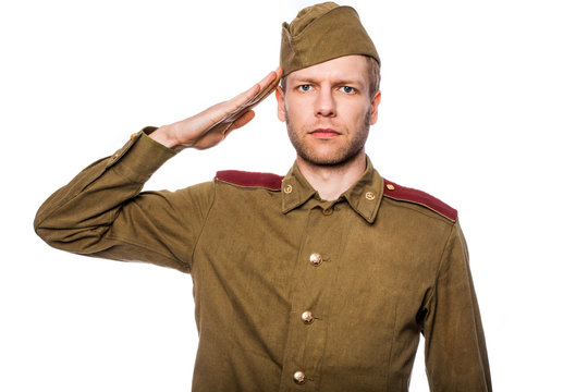 Russian soldier saluting. Studio portrait isolated