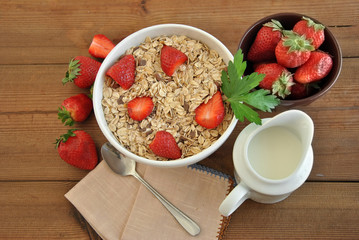 bowl of cereal with milk and strawberries