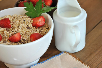 bowl of cereal with milk and strawberries
