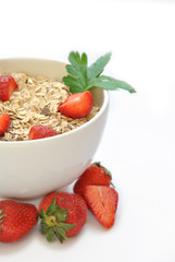bowl of cereal with milk and strawberries