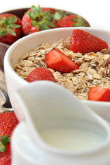 bowl of cereal with milk and strawberries