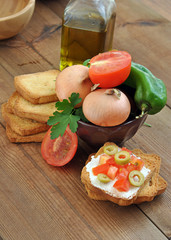 toast with tomato, oil, green olives