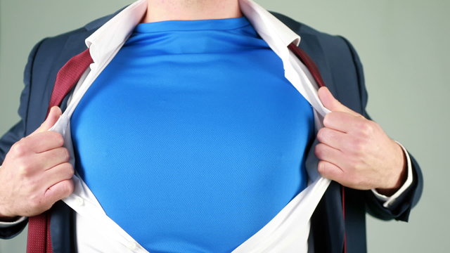 Businessman opening shirt in superhero style