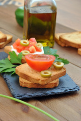 toast with tomato, oil, green olives