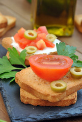 toast with tomato, oil, green olives