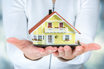 house in woman hands - real estate concept