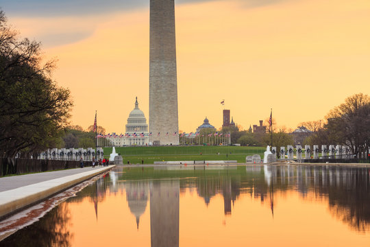 sunrise at dawn reflects Washington Monument
