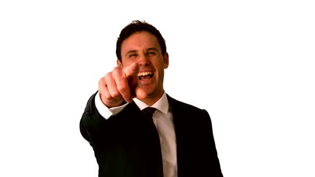 Happy businessman laughing and pointing to camera