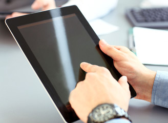 office worker using a touchpad to analyze statistical data 