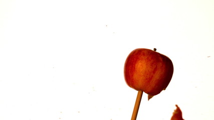 Arrow shooting through red apple on white background - Powered by Adobe