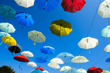 Fototapeta na wymiar Lots of umbrellas coloring the sky in the city of Pai, Thailand