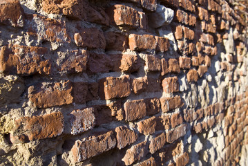 Old weathered brick wall fragment .