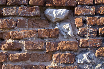 Old weathered brick wall fragment .