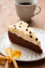 Slice piece of vanilla cake topping with white chocolate chips f