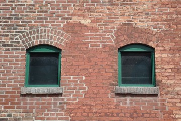 Windows in a brick walled building
