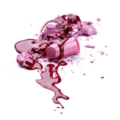 Crushed eye shadow, lipstick and nail polish isolated on white b